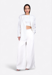 Front view of model wearing white linen blazer, East Vibe